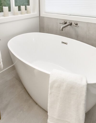 A white bathtub in a modern bathroom.