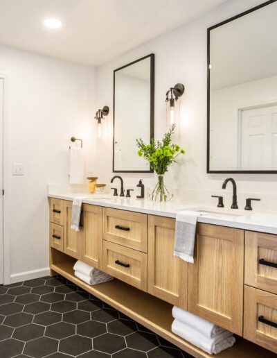 A bathroom with a black hexagon tile floor.