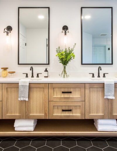 A bathroom with two sinks and two mirrors.